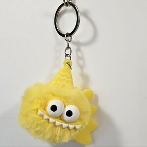Yellow Monster Puff Keychain – Cute Fuzzy Charm with Party Hat